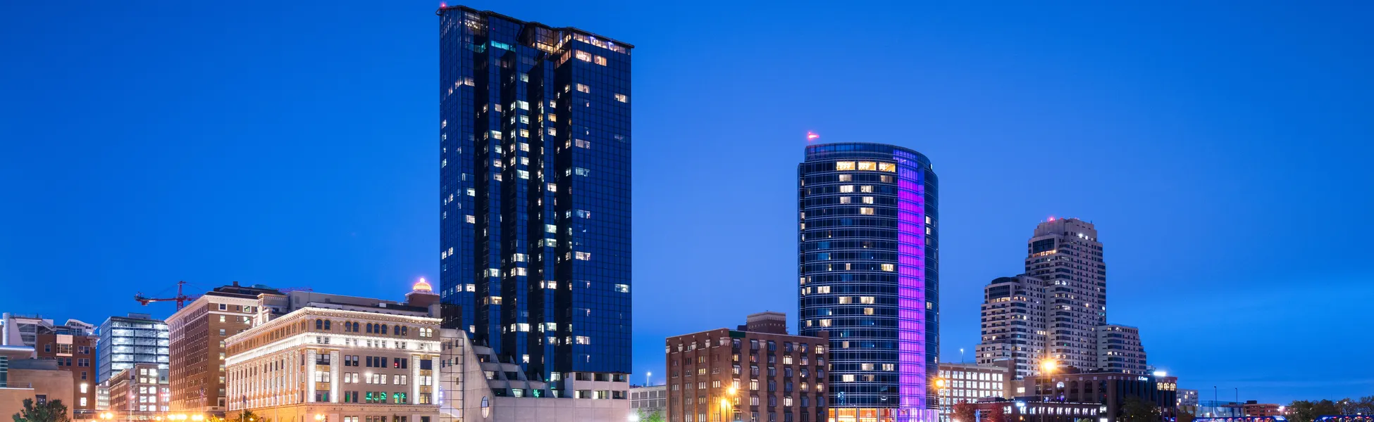 Neon color image of a band playing and people singing along